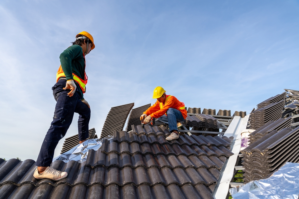 stock photo of construction worker installing new roof